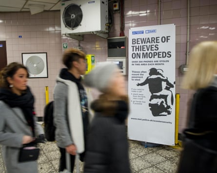 A Met police poster in a tube station warning about thieves on mopeds