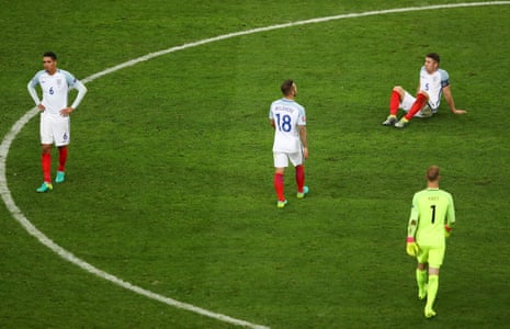 Gary Cahill drops to the floor as the England players show their frustration at the final whistle.