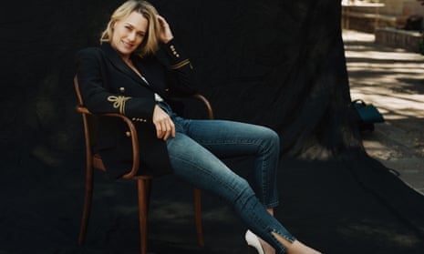 Robin Wright, in jeans and a blazer, sitting