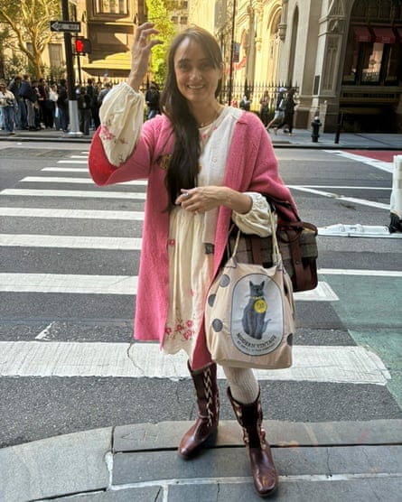 a woman in a dress and pink coat