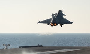 A French army Rafale fighter jet takes off from the aircraft carrier Charles de Gaulle, in the Mediterranean sea.