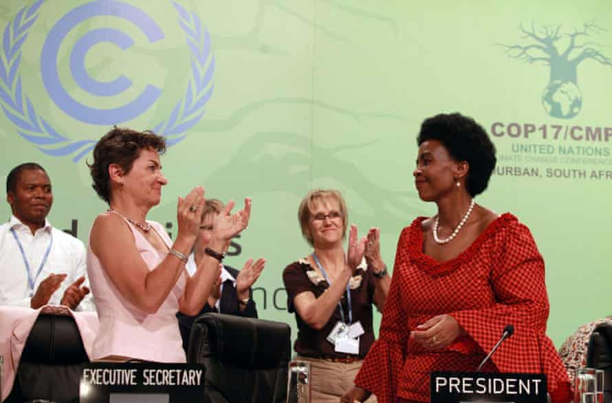 South African international relations minister, Maite Nkoana-Mashabane (right), receives a standing ovation from Figueres and hundreds of delegates at the closing session of the Durban climate talks in December 2011.