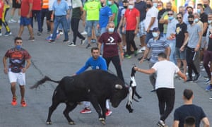 A group of men taunt a bull during the first running of the bulls at the Alfarero de Oro fair in the Toledo town of Villaseca de la Sagra, central Spain