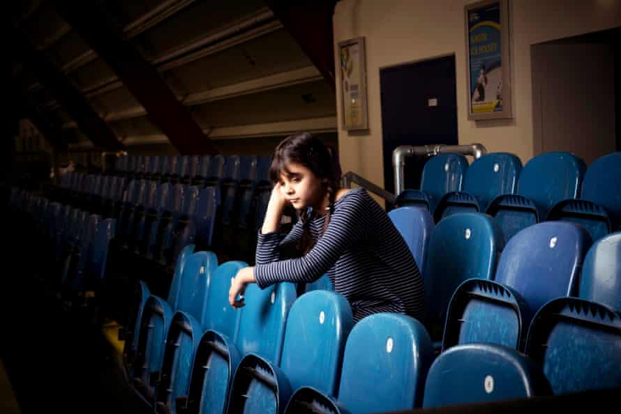 A tired young girl at a sports venue