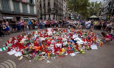 People gather around an impromptu memorial on Las Ramblas in Barcelona.