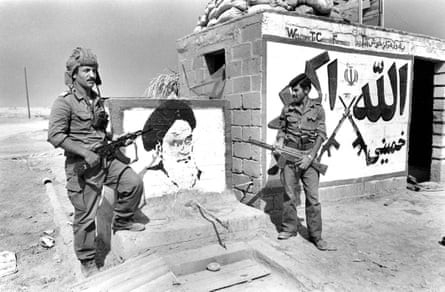 Iraqi soldiers at a captured fortification with a portrait of Ayatollah Khomeini in Iranian territory, 1980