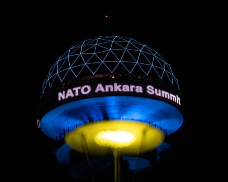 A view of Atakule, one of the landmark buildings of Ankara, is illuminated with the words Nato Ankara Summit