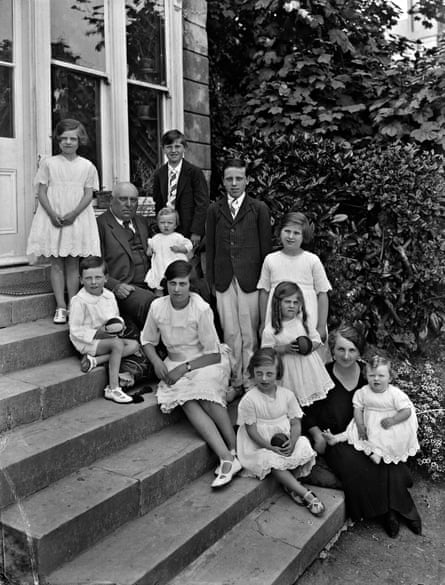 Large family group sitting on the garden steps of a house