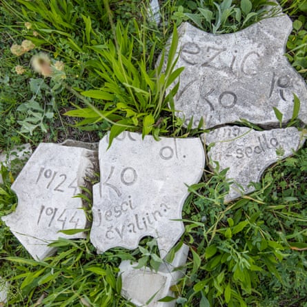 Smashed memorial stones in the grass