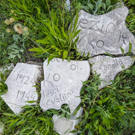 Smashed memorial stones in the grass