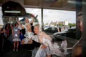 Circus performers cavorting behind glass