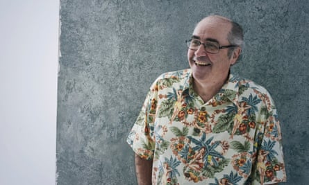 Danny Baker standing, in a Hawiian shirt, hands in pockets, smiling