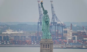 Park police negotiate with a protester who climbed the pedestal of the the Statue of Liberty in New York on Wednesday