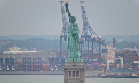 Park police negotiate with a protester who climbed the pedestal of the the Statue of Liberty in New York on Wednesday