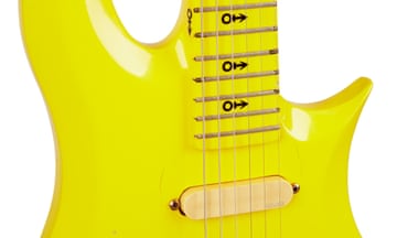 Closeup of the yellow Cloud 3, which has  circle and arrow symbols on the fret board