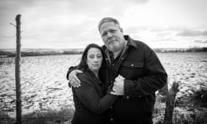 Nacole and Tom, parents of JS, standing in a snowy field