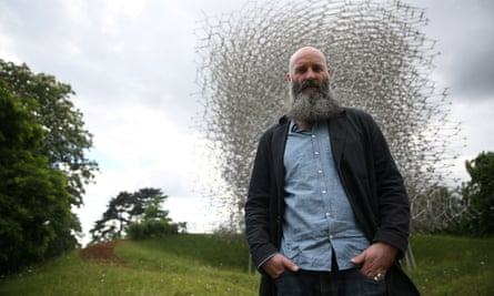 Artist Wolfgang Buttress poses with his sculpture