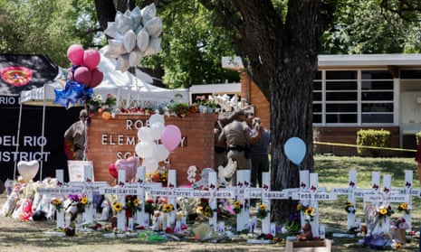 Crosses bearing names of victims line a school ground area following a mass shooting in Uvalde, Texas.