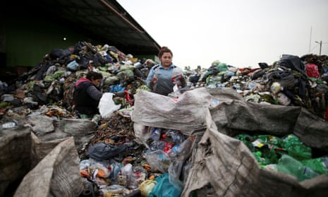 A waste picker sifts through trash in the neighbourhood of Jose Leon Suarez, on the outskirts of Buenos Aires