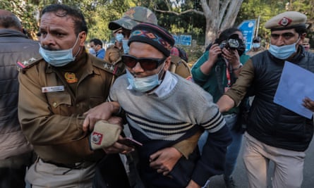 Indian security personnel detain Jawaharlal Nehru University students as they protest against hijab (headscarf) restriction in February.