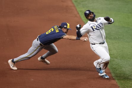 Brewers infielder David Hamilton attempts to tag Rays runner Junior Caminero during the fourth inning of Game 4 of the World Series on Tuesday night.