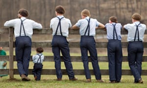 Amish boys watch a game of baseball. In the population studied, those with the mutation were found to have better metabolic health, far less diabetes, and tended to live a decade longer than others without the mutation.