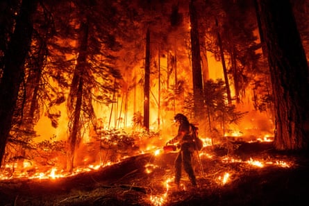 A firefighter works to contain a fire