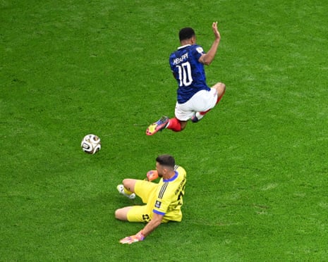 Spain’s keeper Unai Simon (left) clears the ball away from France's Kylian Mbappe.