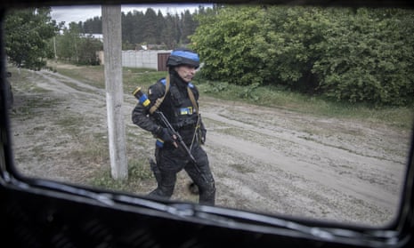 A police officer inspects a neighbourhood for evacuation of civilians on a village nearby Vovchansk city, in Kharkiv oblast, Ukraine.