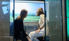 Two women sit in a prototype of the sleek, modern carriage.