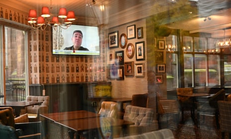 Andy Burnham on TV in a deserted pub in Manchester.