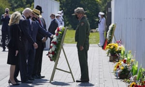 President Joe Biden, second from left, and First Lady Jill Biden, left, help place a wreath at the Wall of Names at the Flight 93 National Memorial with Gordon Felt, third from left, who lost his brother in the crash