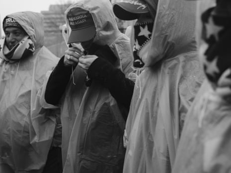 three men standing wearing rain ponchos