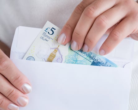 Money and white envelope in woman’s hands
