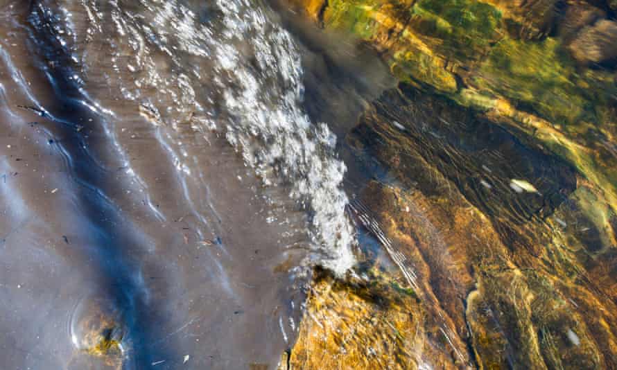 Raw sewage mixing with clean clear water in the river Kent in Kendal, Cumbria, UK.
