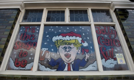 Pub window in Southend-on-Sea with caricature of Boris Johnson and words 'it's the season to be jolly careful'