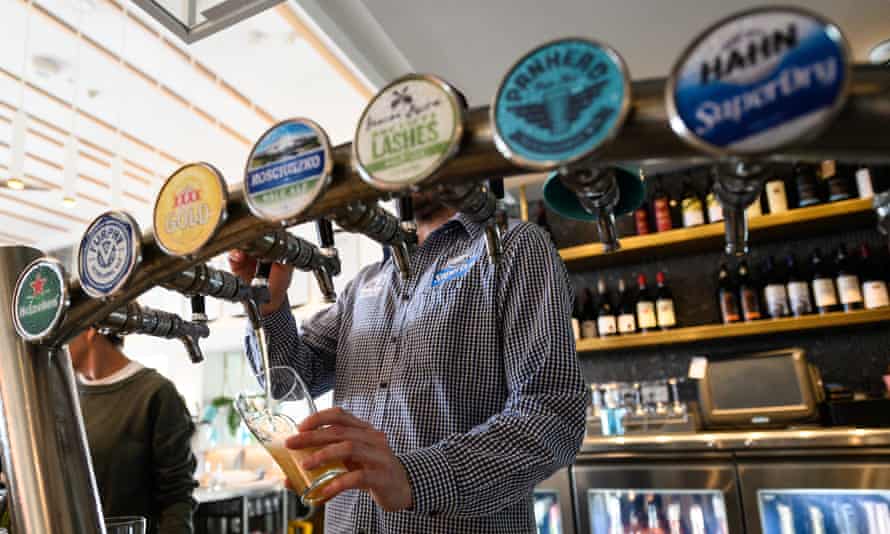A bartender pours a beer in a bar in Sydney, Australia