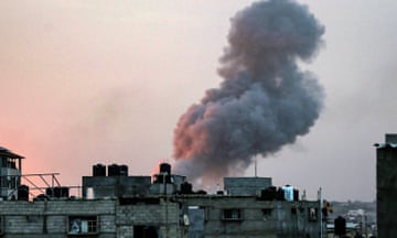 Smoke rises above buildings during an early morning Israeli strike on Rafah in the southern Gaza Strip on 11 May.