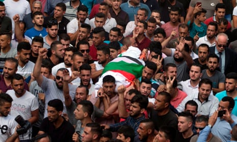 Palestinians carry the body of Aisha Rabi during her funeral in the West Bank village of Biddya