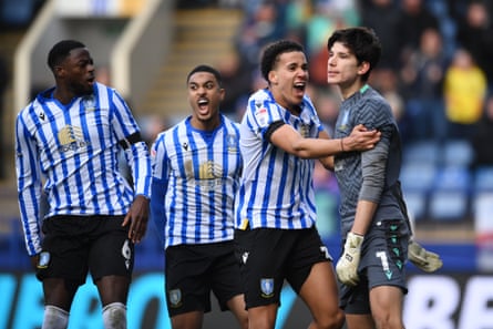 Sheffield Wednesday players mob keeper James Beadle after his penalty save.