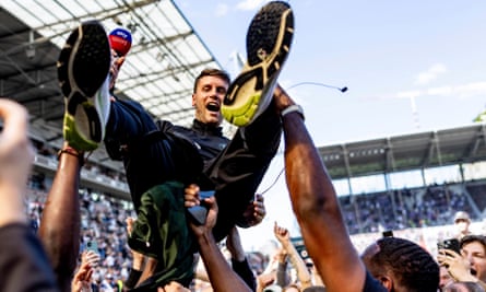 Fabian Hürzeler is lifted up by fans in celebration after promotion