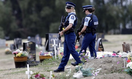 Armed police patrol a cemetery near Muslim graves in Christchurch.