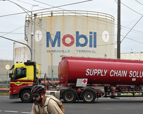 A truck transporting petroleum fuel passes by signage at the ExxonMobil Yarraville Terminal in Melbourne in March.