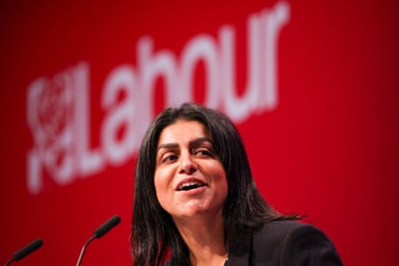 Mahmood speaking in front of a Labour logo