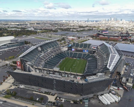 An aerial view of Lincoln Financial Field with the Philadelphia skyline in the background.