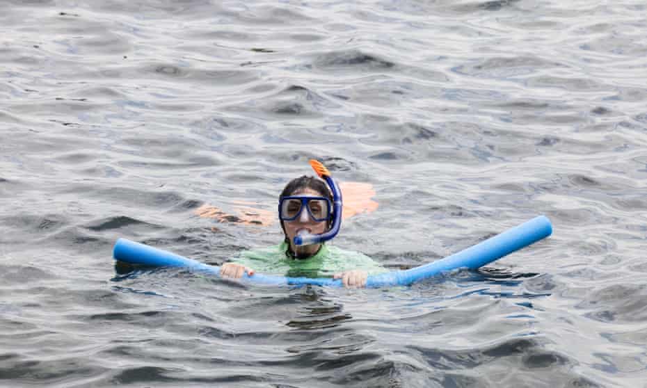 Guardian Australia journalist Rafqa Touma breaches the surface during her first time snorkelling, at Cabbage Tree Bay on Sydney’s Northern Beaches.