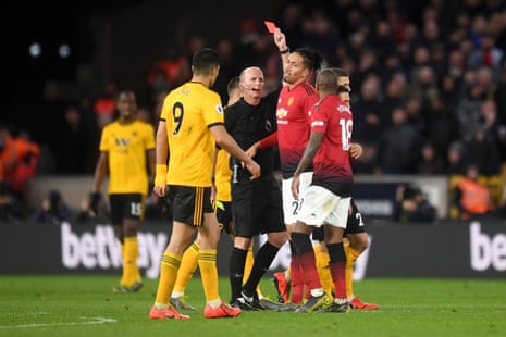 Referee Mike Dean hands out his 100th red card.