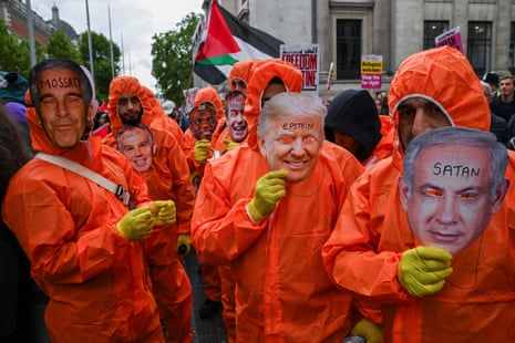 People in orange jumpsuits with masks of US President Donald Trump, Israel’s prime minister Benjamin Netanyahu, Jeffrey Epstein, former UK prime minister Tony Blair, Reform UK Leader Nigel Farage and Justice Secretary David Lammy.
