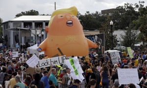 A Trump baby blimp towers over protesters near the arena where Trump held his rally in Orlando, Florida, on 18 June.