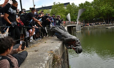 Protesters throwing a statue of the slave owner Edward Colston into Bristol harbour during a Black Lives Matter protest rally.